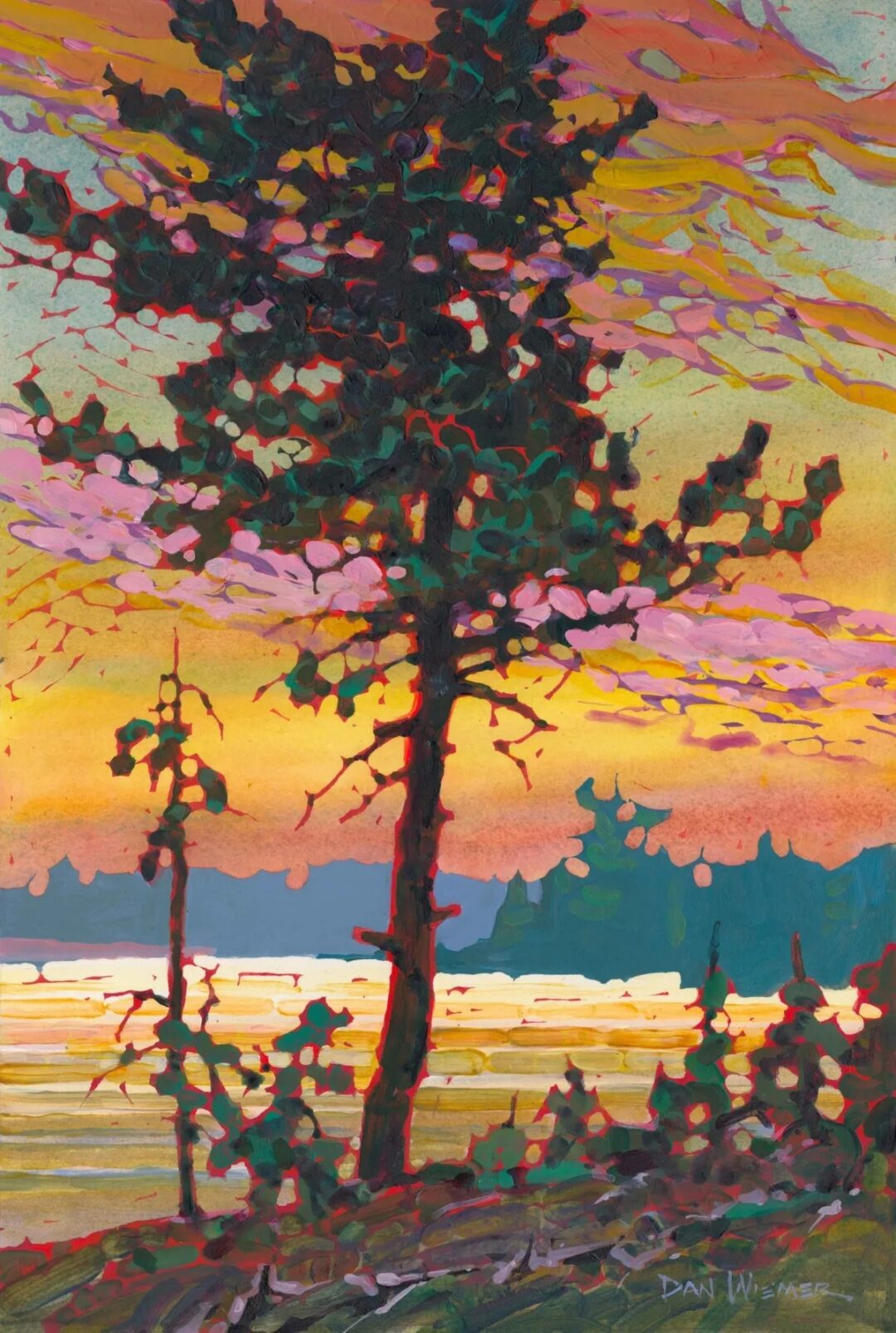 Vibrant sunset behind silhouetted tree.