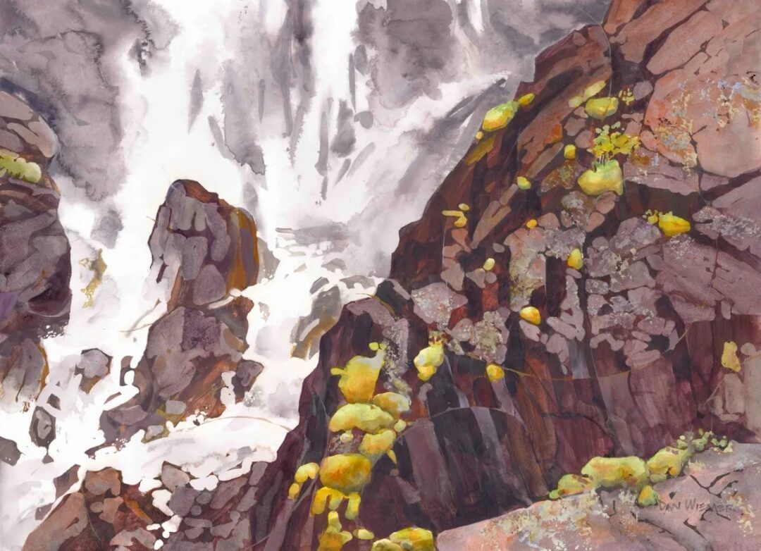 Colorful rocks with cascading water in background.